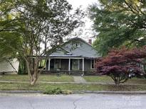 Charming home with inviting front porch, mature trees, and traditional architectural details at 613 E 5Th St, Spencer, NC 29159