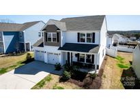 Beautiful two-story home featuring a two-car garage and well-manicured landscaping at 1090 River Haven Sw Ave # 61, Concord, NC 28025