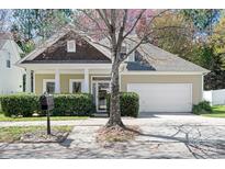 Charming single-Gathering home featuring a well-manicured lawn, attached garage, and inviting front porch at 19221 Coachmans Trce, Cornelius, NC 28031