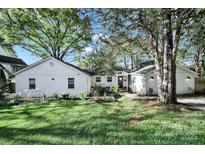 Charming single-story home featuring a well-manicured lawn and a beautifully landscaped front yard at 2314 Wolfe St, Charlotte, NC 28205