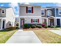 Charming townhome with neat landscaping and inviting curb appeal on a sunny day at 309 River Clay Rd, Fort Mill, SC 29708