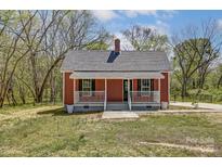 Charming red home featuring a cozy front porch and classic architectural details at 50 Sixth St, York, SC 29745