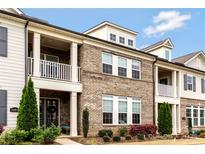 Charming brick townhome with landscaped front yard, covered porch, and ample natural light streaming through the windows at 11019 Kilkenny Dr # 41, Charlotte, NC 28277