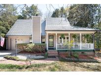 Charming home featuring a cozy front porch and well-maintained landscaping at 11901 Rock Canyon Dr, Charlotte, NC 28226