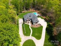 Stunning aerial view showcases circular driveway and lush wooded surroundings at 4071 King Wilkinson Rd, Lincolnton, NC 28092