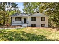 Charming renovated home featuring a classic white painted brick exterior with dark window shutters at 6614 Old Providence Rd, Charlotte, NC 28226