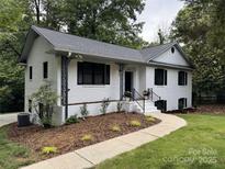 Charming brick home with updated landscaping, black shutters, and a inviting front porch at 6614 Old Providence Rd, Charlotte, NC 28226