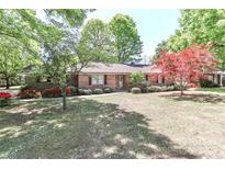 Charming brick home with mature trees and landscaping, creating a welcoming curb appeal at 783 Carpenter Ave, Mooresville, NC 28115
