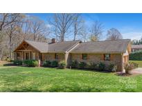 Charming brick home with a well-maintained lawn and inviting front porch at 8194 Mallard Rd, Denver, NC 28037