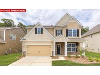Charming two-story home featuring a welcoming front porch, manicured lawn, and attached two-car garage at 116 Fordingbridge Ln, Mooresville, NC 28115