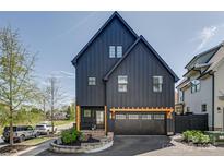 Modern two-story home with a black exterior, a garage, and neatly landscaped front yard at 1505 Landis Ave, Charlotte, NC 28205
