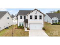 Charming two-story home with a two-car garage, well-maintained lawn, and neutral-toned exterior at 1976 Ethan Ln, Stanfield, NC 28163