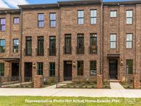 Beautiful brick townhome with charming entryways and well-maintained landscaping at 212 Gilead Rd, Huntersville, NC 28078
