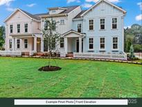 Charming townhomes featuring colorful exteriors, covered entrances, and a well-manicured lawn with white picket fences at 280 Gilead Rd, Huntersville, NC 28078