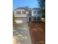 Two-story home with gray and blue siding, black shutters, and a spacious concrete driveway at 436 Phifer Rd, Kings Mountain, NC 28086