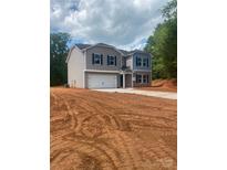 Charming two-story home with blue shutters, a two-car garage and unfinished landscaping at 436 Phifer Rd, Kings Mountain, NC 28086
