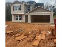 Two-story home featuring an attached two-car garage and red shutters, set against a natural backdrop at 438 Phifer Rd, Kings Mountain, NC 28086