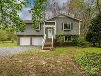 Charming two-story home with a two-car garage and inviting front porch at 5601 Indian Brook Dr, Matthews, NC 28104