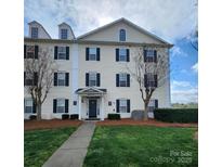 Inviting exterior of building with lush lawn, landscaping, and classic architectural details at 6423 Town Hall Pl, Harrisburg, NC 28075