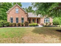 Charming brick home features a well-manicured front yard and a welcoming entrance at 9506 Minnie Lemmond Ln # 170, Mint Hill, NC 28227