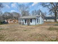Charming single-story home with freshly painted exterior and well-manicured front lawn at 200 W Shannonhouse St, Shelby, NC 28152