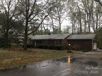Charming brick home with a well-maintained lawn and lush landscaping at 235 John Rainey Rd, Salisbury, NC 28147