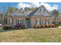 Beautiful home featuring a brick facade and a manicured front lawn at 304 Wintergreen Ct, Kings Mountain, NC 28086