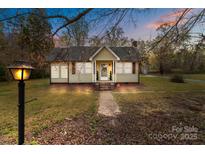 Charming single-story home with a walkway leading to the front door and a well-maintained lawn at 325 Hurley School Rd, Salisbury, NC 28147