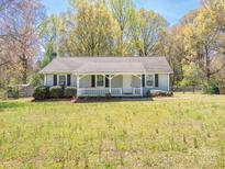 Charming single-story home with a cozy front porch and a large yard at 524 Catawba N Cir, Matthews, NC 28104