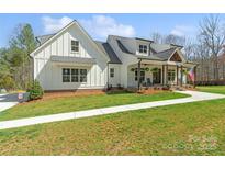 Charming white farmhouse-style home with a welcoming front porch and well-manicured lawn at 722 Clegg Farm Dr, York, SC 29745