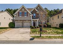 Charming two-story home with brick accents, a two-car garage, and well-maintained landscaping at 10728 Bere Island Dr, Charlotte, NC 28278