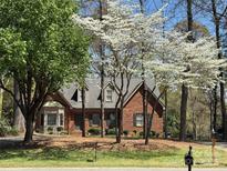 Beautiful brick home with mature trees and landscaping in a quiet neighborhood at 119 Lakenheath Ln, Matthews, NC 28105