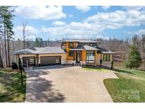 Stunning modern home with three-car garage, beautiful landscaping, and a private driveway at 233 Conifer Way, Shelby, NC 28150