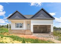 New construction home with white siding, brick foundation, and a two-car garage in a rural setting at 2508 Rock Dam Rd, Lincolnton, NC 28092