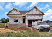 A new construction home featuring brick foundation and two-car garage with a work van at 2508 Rock Dam Rd, Lincolnton, NC 28092