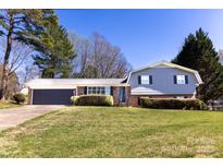 Inviting two-story home with a well-manicured lawn and mature trees, offering great curb appeal at 2650 31St Street Ne Ct, Hickory, NC 28601