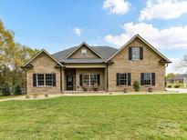Charming brick home with a manicured lawn, covered porch, and classic black shutters at 3012 Ocean Dr, Monroe, NC 28110