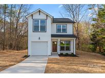 Charming two-story white home featuring a garage and a well-manicured lawn at 4219 Brownwood Nw Ln, Concord, NC 28027