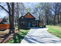 Charming home with a welcoming blue door, well-manicured lawn and lengthy driveway at 782 Chalice Sw St, Concord, NC 28027