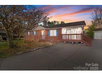 Charming brick home with light blue shutters, front porch, and a spacious driveway at 1104 Crestview Dr, Salisbury, NC 28146