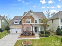 Attractive two-story home featuring a well-manicured lawn, and a two-car garage at 1224 Screech Owl Rd, Waxhaw, NC 28173