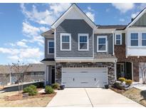Two-story townhome featuring a gray facade, attached two-car garage, and landscaping at 1243 Pebble Grove Dr # 442, Clover, SC 29710