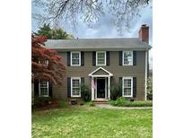 Charming two-story home with dark shutters, beautiful lawn, chimney, and manicured landscaping at 1650 Maryland Ave, Charlotte, NC 28209