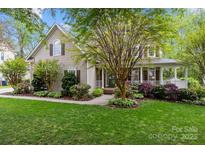 Charming two-story home with beautifully landscaped front yard and welcoming porch at 17301 Glassfield Dr, Huntersville, NC 28078
