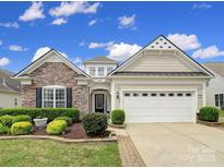 Charming home featuring stone accents, lush landscaping, and an attached two-car garage at 2158 Hartwell Ln, Fort Mill, SC 29707