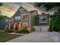 Charming two-story home with attached two-car garage, landscaped front yard, and inviting front porch at 2220 Gallberry Ln, Waxhaw, NC 28173