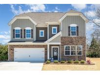 Charming two-story home featuring stone accents, a two-car garage, and a well-maintained lawn at 2248 Killian Creek Dr, Denver, NC 28037
