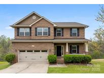 Charming two-story brick home with a covered porch and well-manicured landscaping at 2548 Flintshire Ln, Gastonia, NC 28056