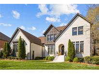 Beautiful exterior elevation showcases the manicured lawn and modern design of this two-story home at 318 Montrose Dr, Waxhaw, NC 28173