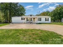 Charming home featuring a well-maintained front yard, white siding, and a cozy covered porch at 4767 Stratford Ln, Denver, NC 28037